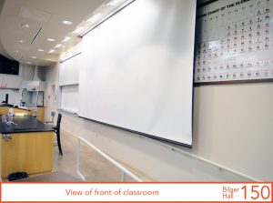 View of front of classroom, projection screen down