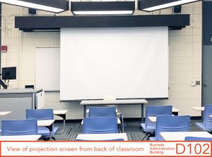 View of projection screen from back of classroom